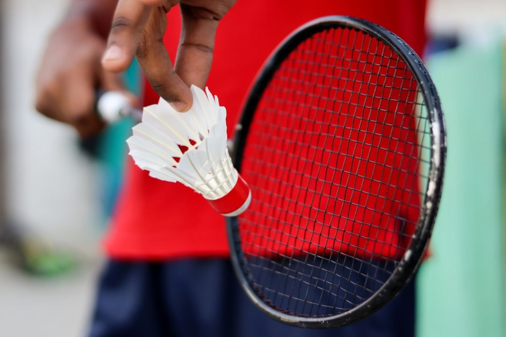 Badminton player holding racket with Badminton Shuttlecock.